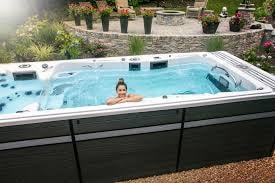Family enjoying an Aspen swim spa outdoors